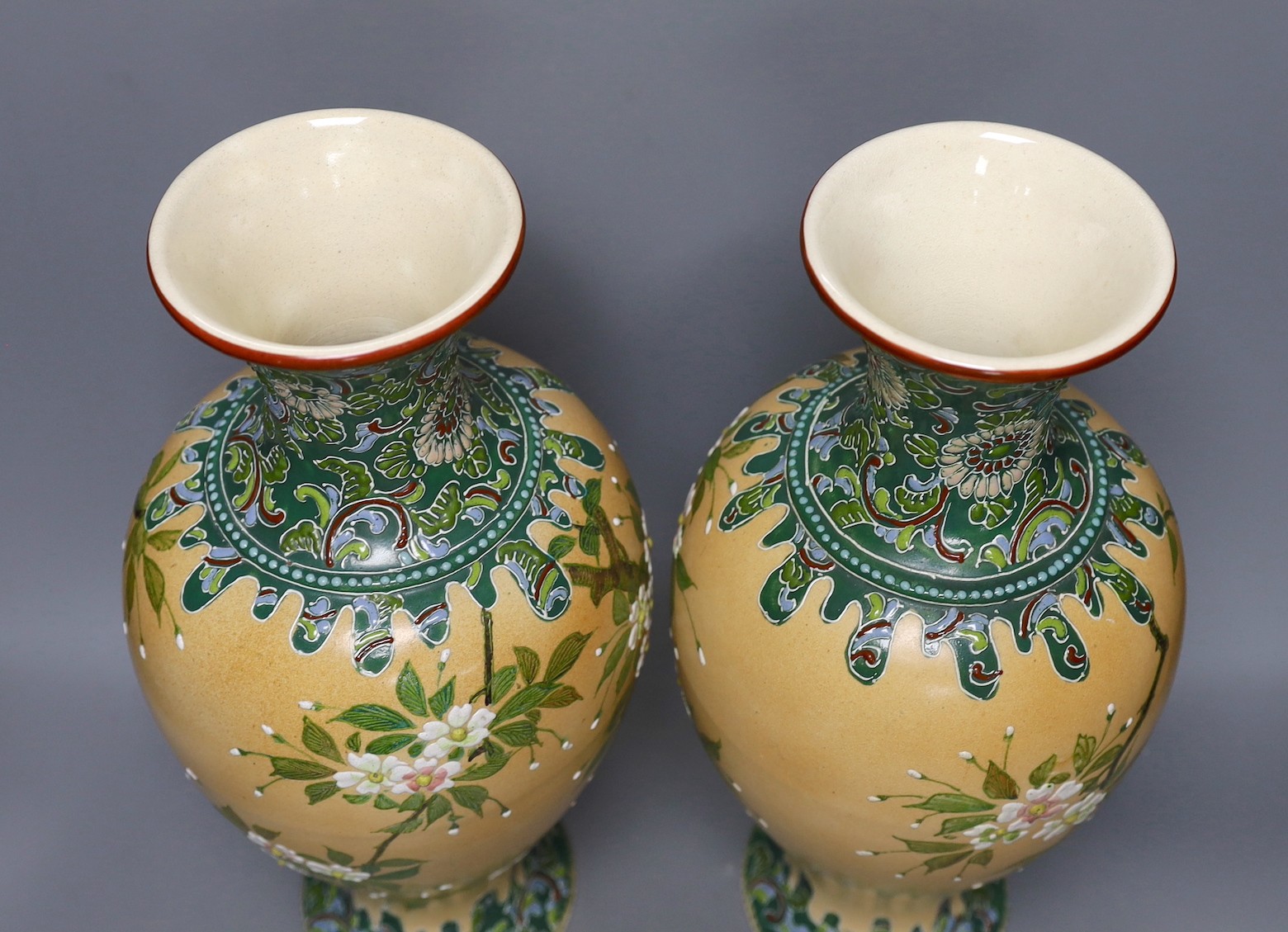 A pair of Japanese Satsuma style cream ground moriage vases, 40cm